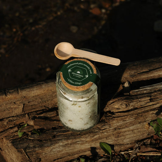 enchanted woods - serenity soak the alambique - sitting on a log with mini wooden spoon