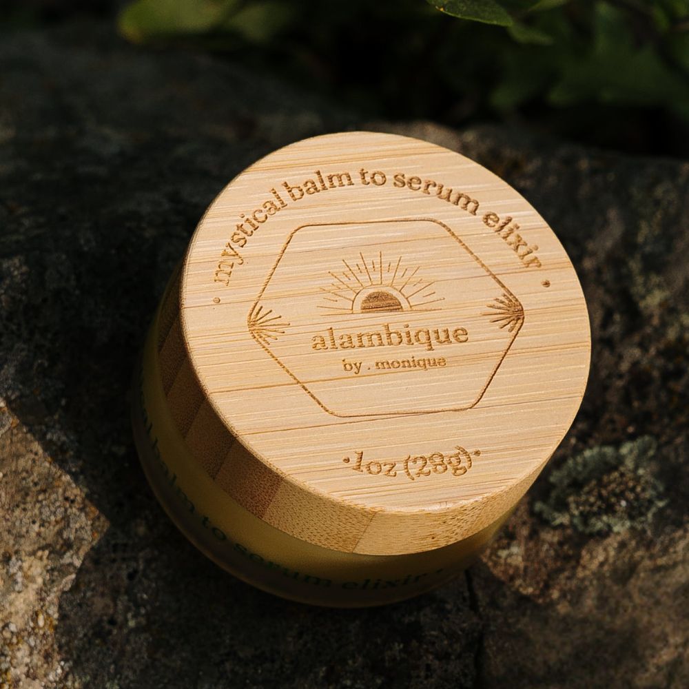 mystical balm to serum elixir •sitting on a rock - product has an engraved bamboo cap