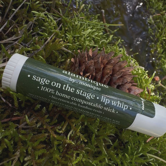 a compostable lip balm stick in a bed of moss