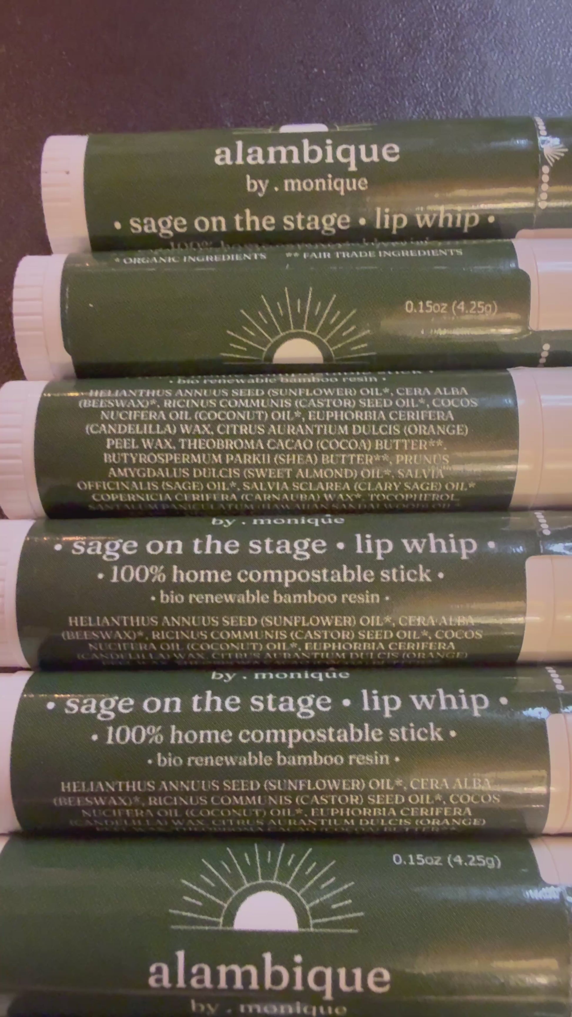 a compostable lip balm stick rolling on a desk