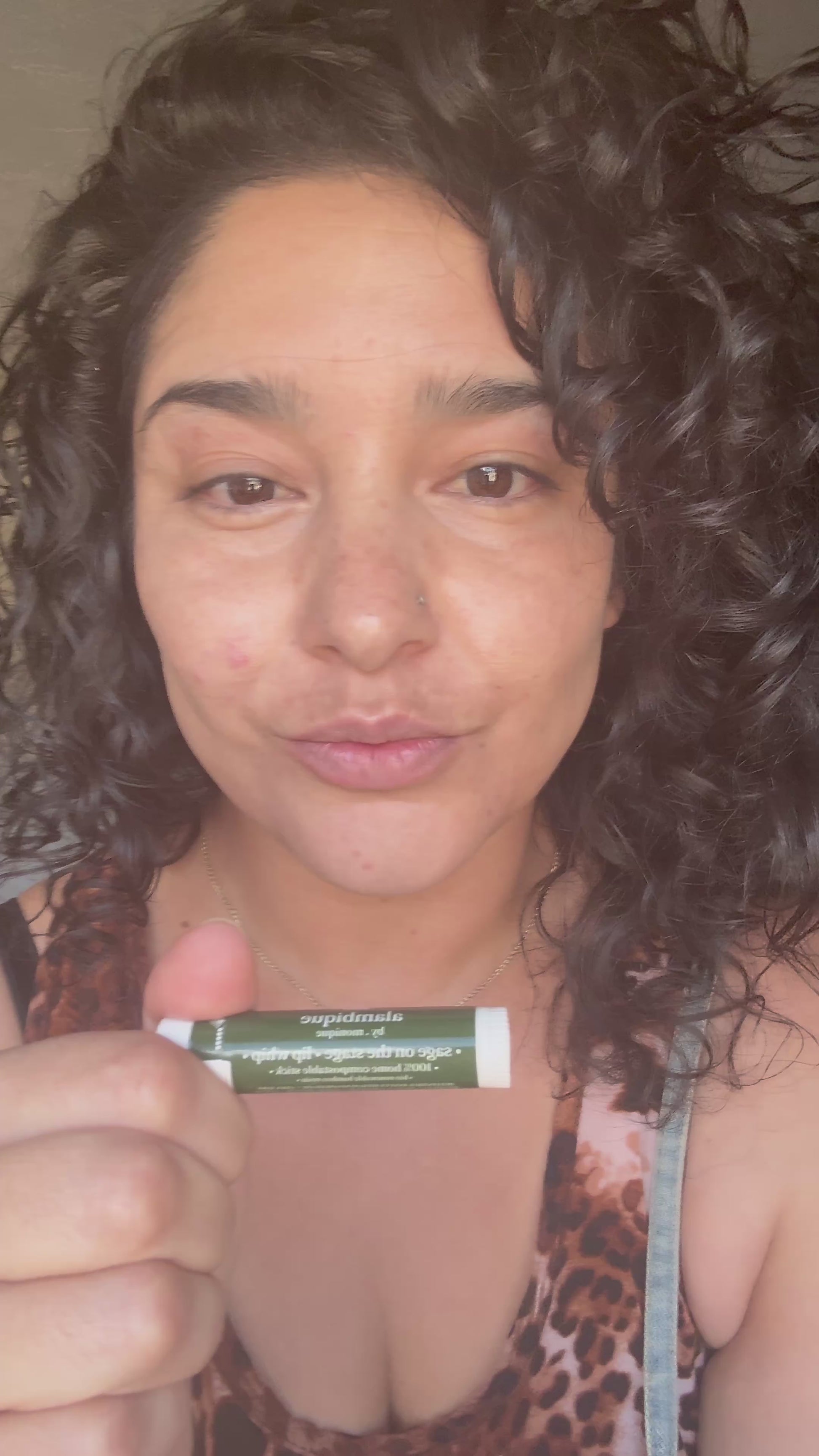 woman putting on a compostable lip balm stick